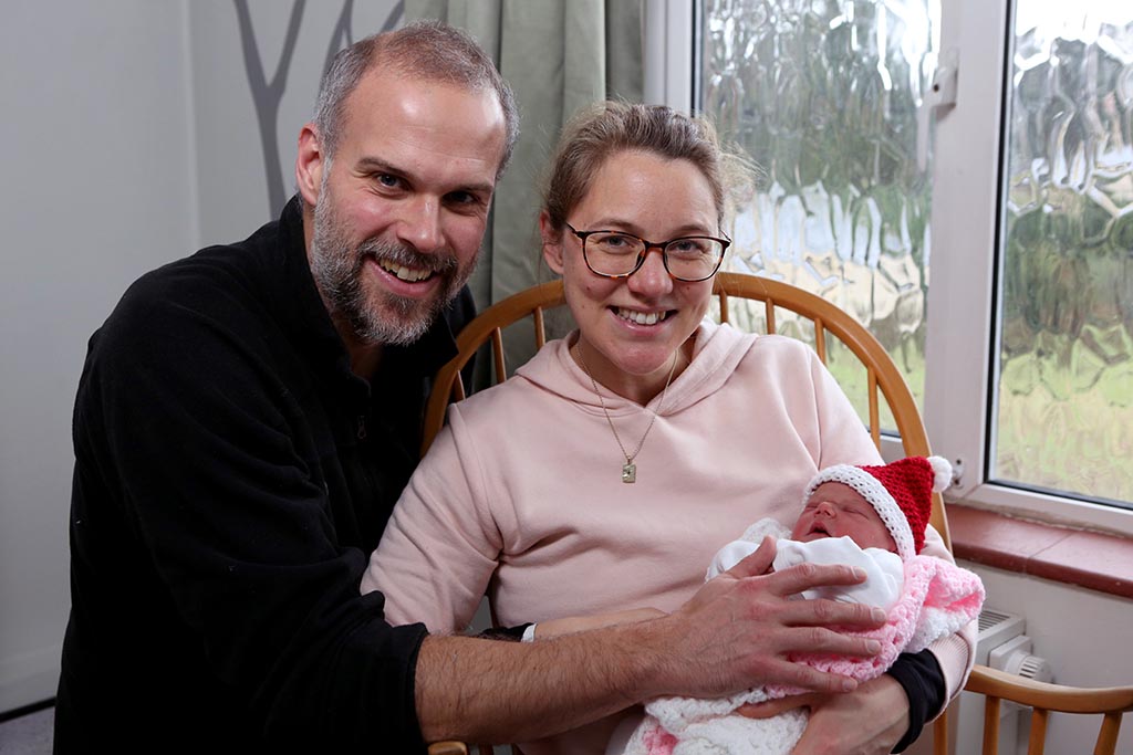 Families celebrate Christmas with their new babies. Wilson | Families celebrate very special Christmas gifts